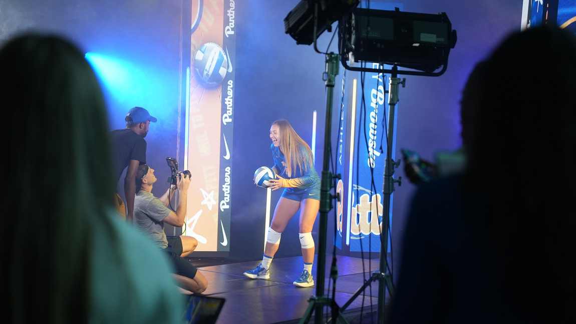 Davone filming a Pitt Volleyball player on the lit media-day set
