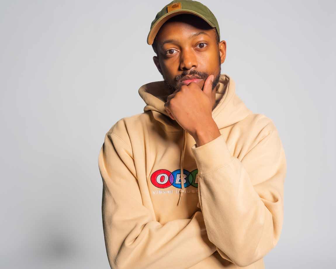 Portrait of Davone in a tan hoodie