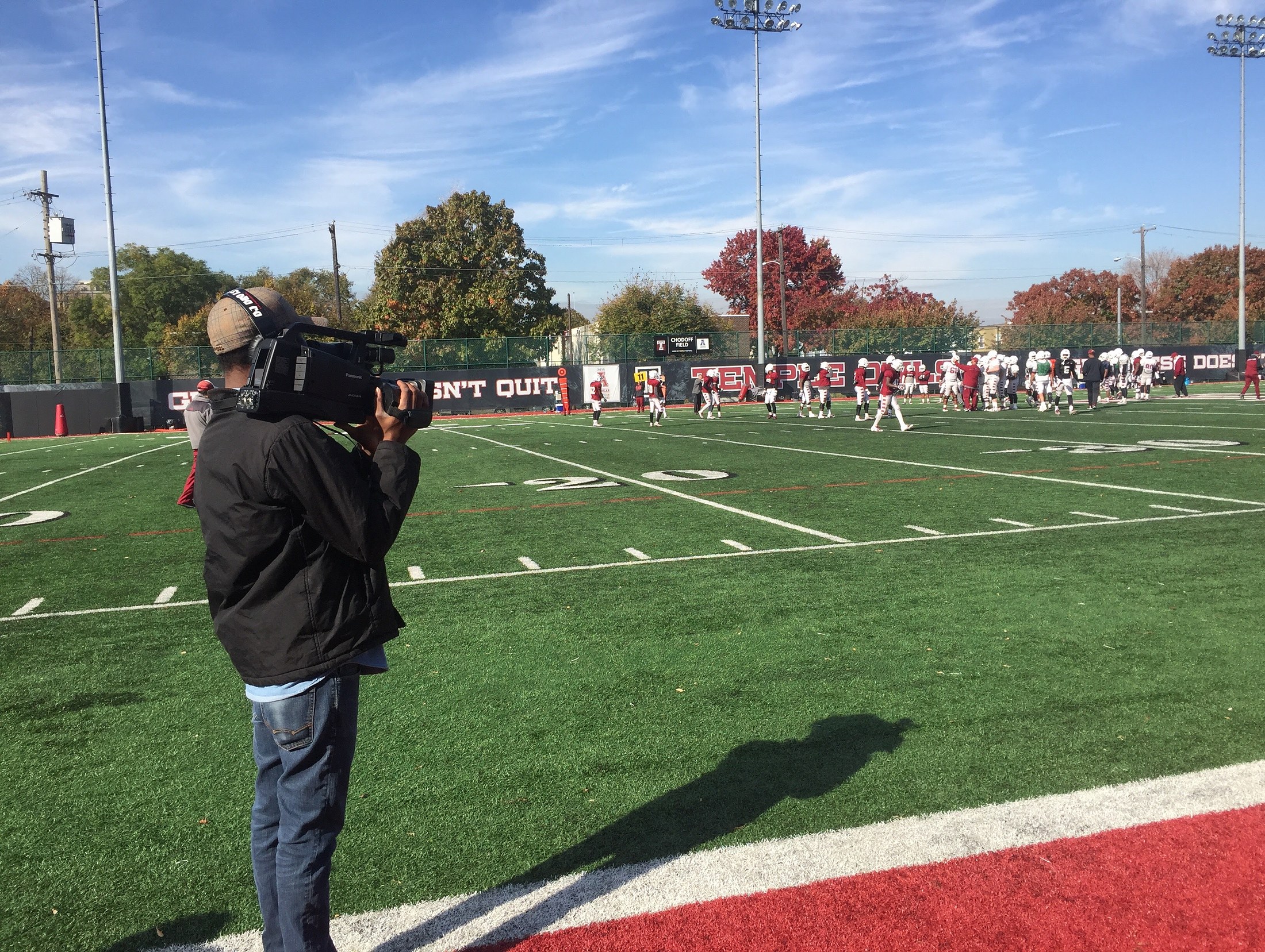 Davone shooting Temple Football from the sideline