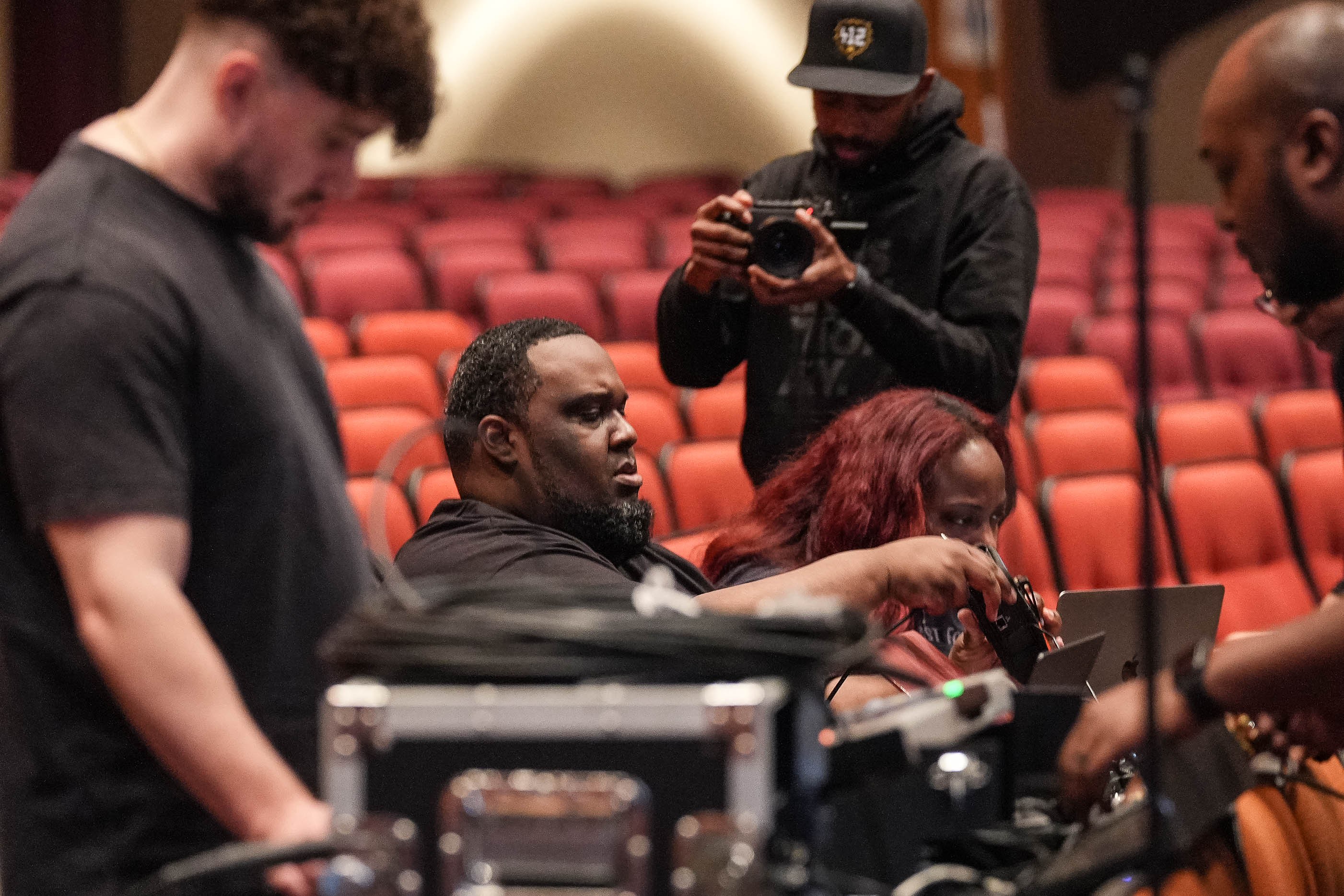 Davone and crew setting up cameras in a theater
