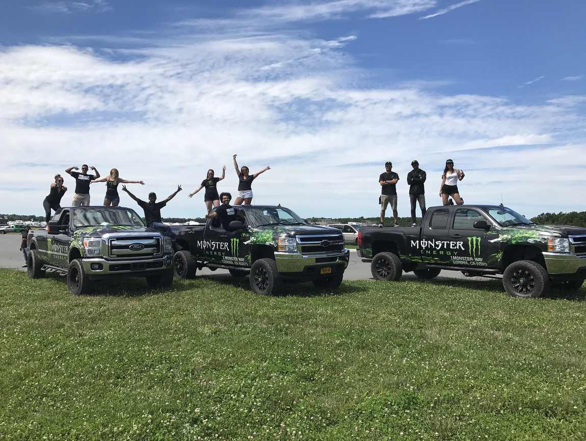 The Monster Energy team on the brand trucks