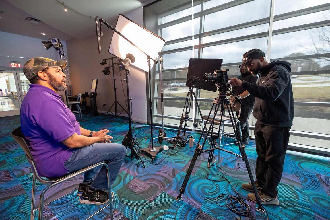 Davone setting up a Prime People interview at Riverside EpiCenter, the article’s lead photo