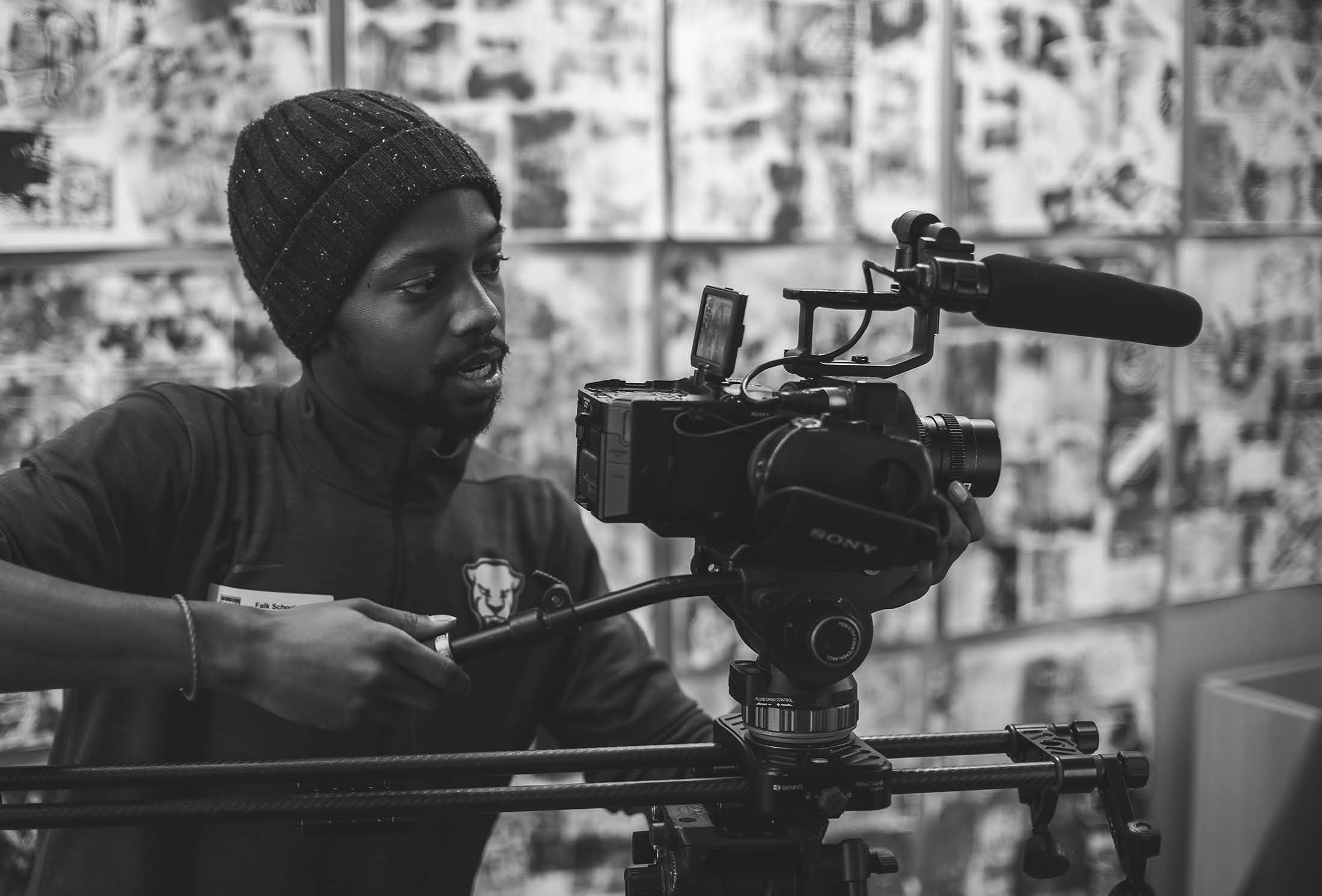 Davone behind a cinema camera on a slider, in black and white